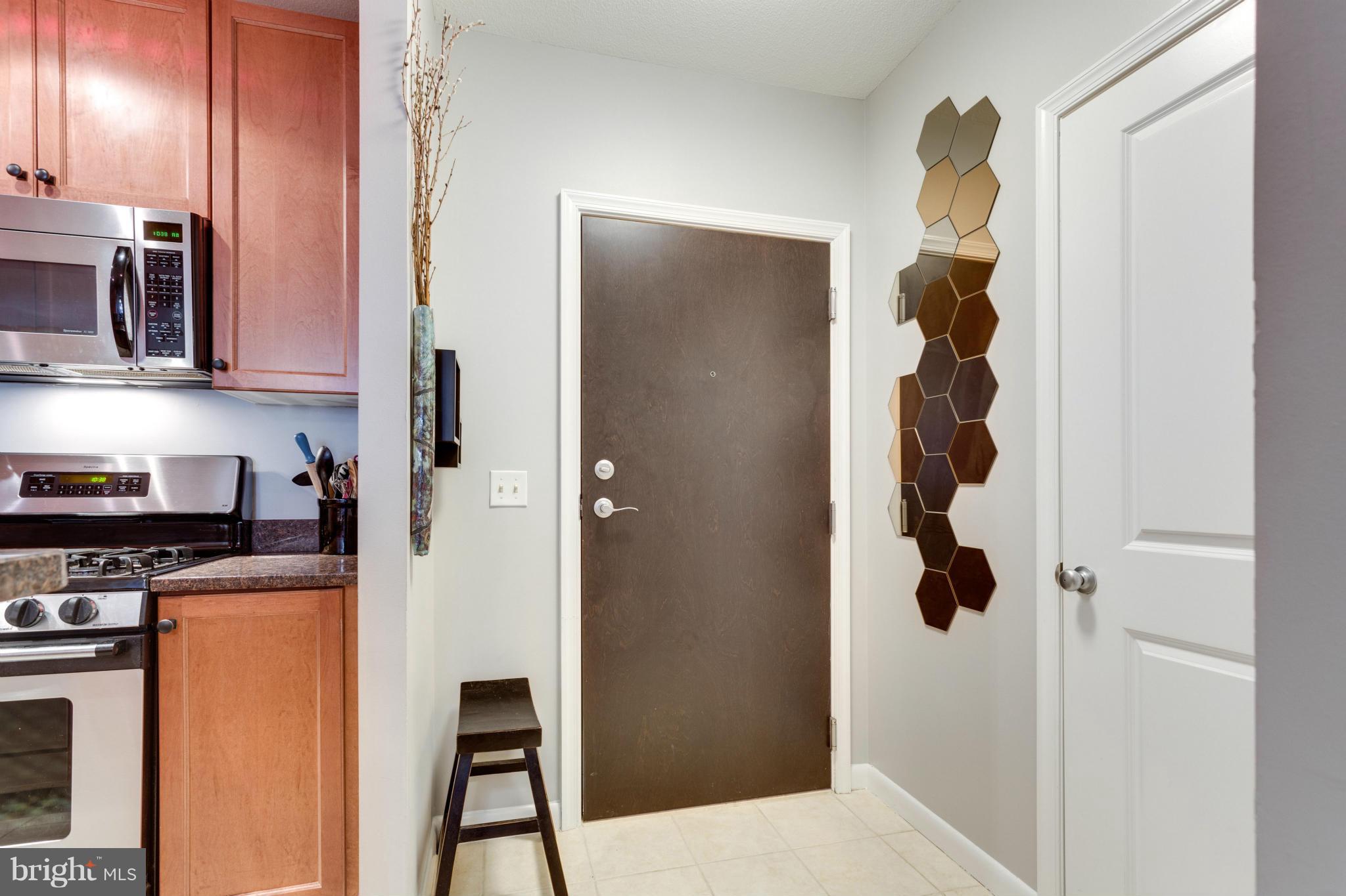 851 North Glebe Road, Unit 501 Arlington, VA 22203 - Photo 4 of 30 a kitchen with a refrigerator and cabinets