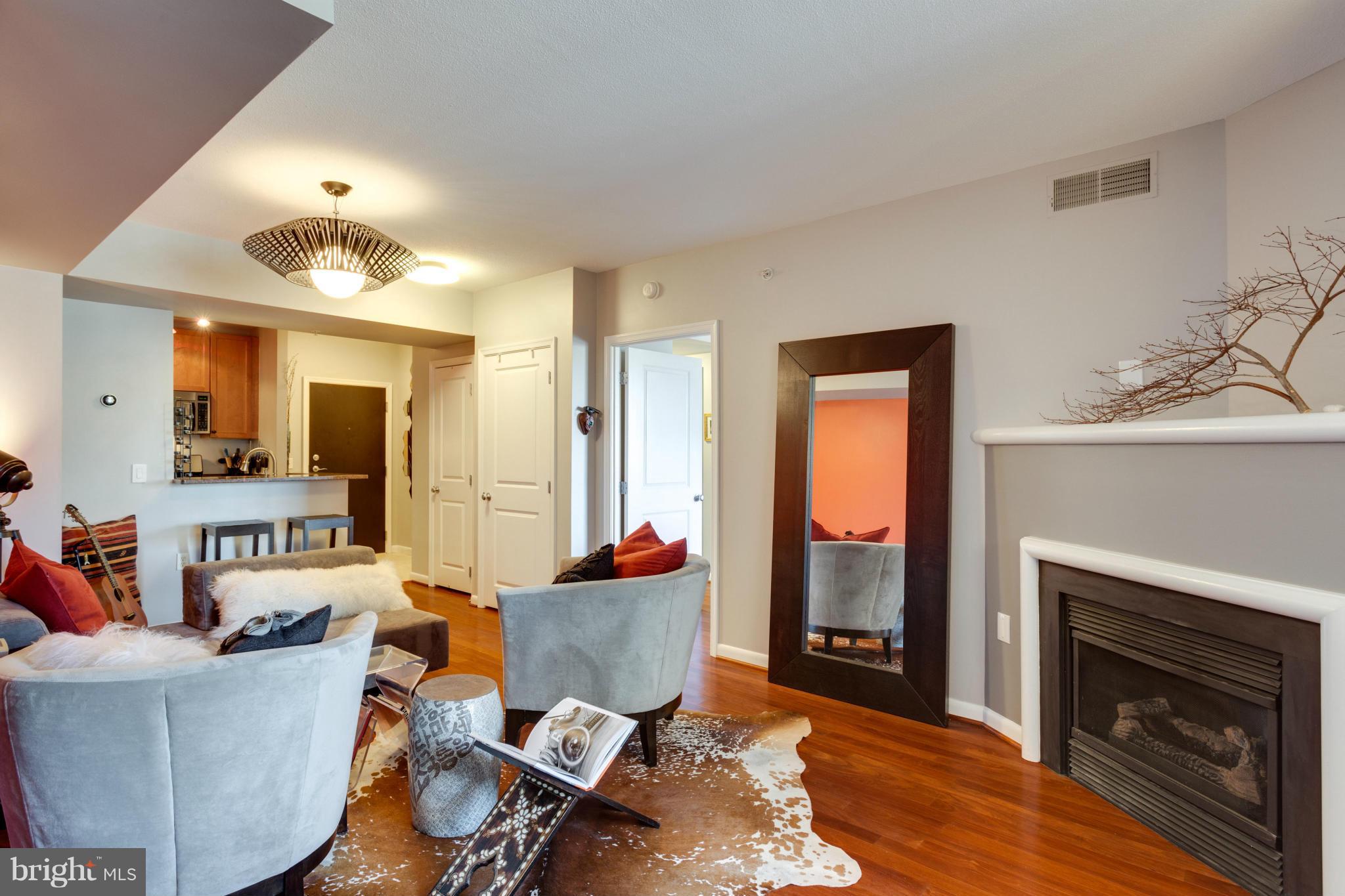 851 North Glebe Road, Unit 501 Arlington, VA 22203 - Photo 6 of 30 a living room with furniture a fireplace and a flat screen tv