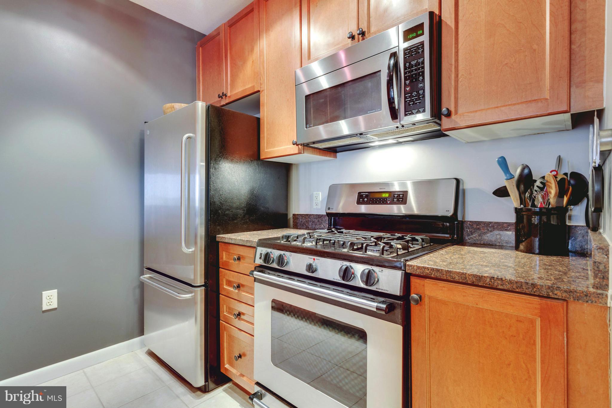 851 North Glebe Road, Unit 501 Arlington, VA 22203 - Photo 10 of 30 a kitchen with stainless steel appliances granite countertop a stove and a refrigerator