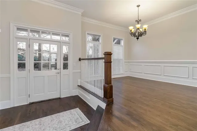 a view of a room with wooden floor and window