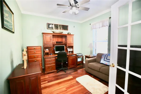 a living room with furniture ceiling fan and a flat screen tv