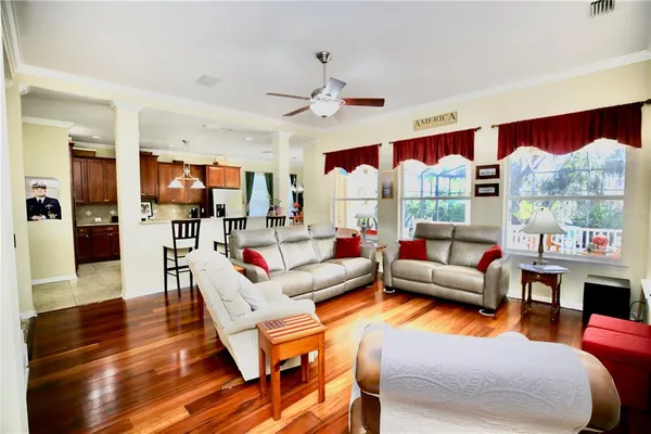 a kitchen with stainless steel appliances granite countertop a stove a sink dishwasher and a dining table with wooden floor