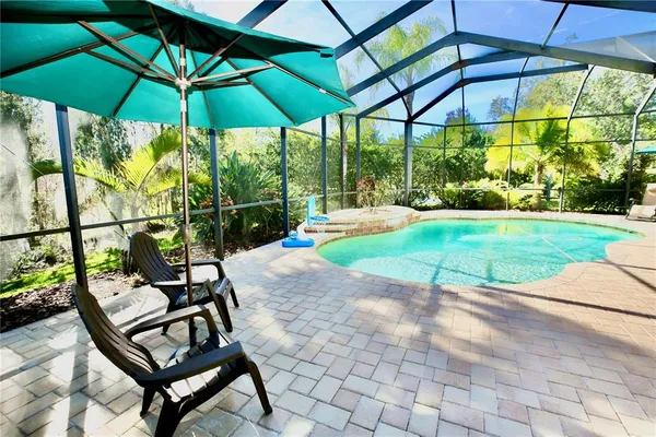 a view of a backyard with a patio and outdoor seating
