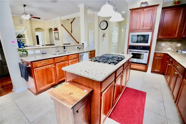 a spacious bathroom with a double vanity sink a mirror a bathtub and window