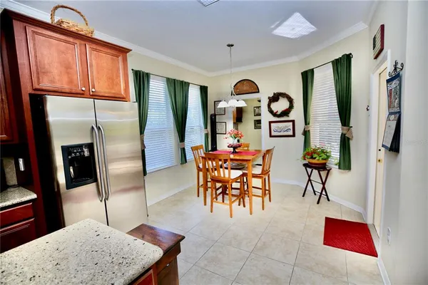 a living room with furniture a flat screen tv and a chandelier