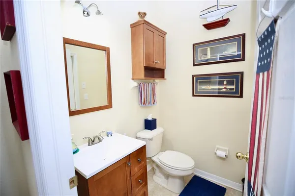 a bedroom with a bed and a dresser next to a window