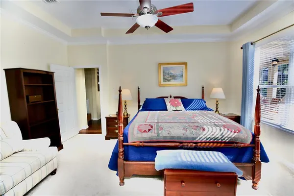 a bathroom with a granite countertop sink a toilet a mirror and shower