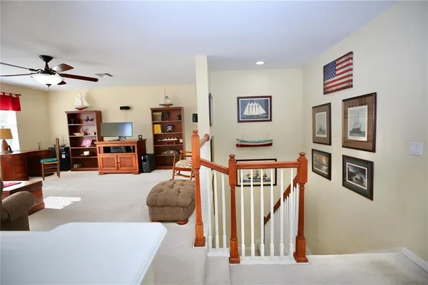an aerial view of a house with a yard and trees all around