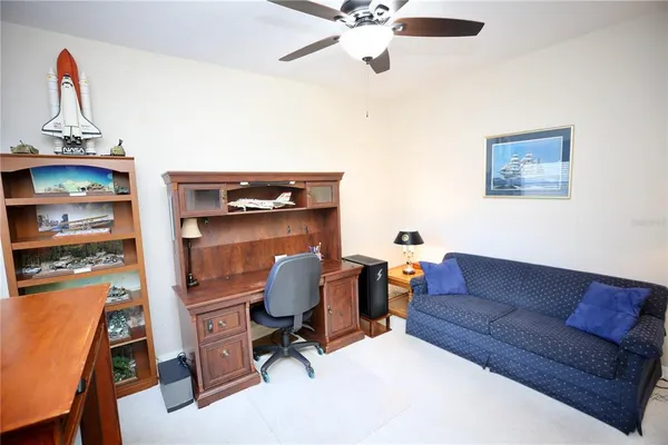 an aerial view of residential house with outdoor space and trees all around