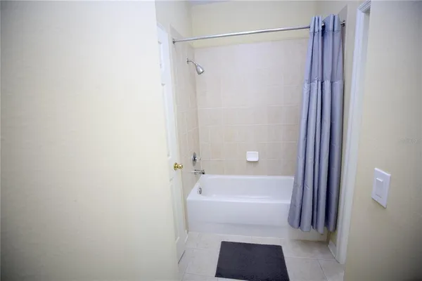 an aerial view of residential house with outdoor space and trees all around