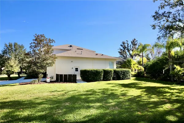 a living room with furniture kitchen view and a large window