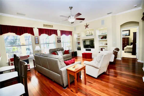 a view of a dining room with furniture and a chandelier