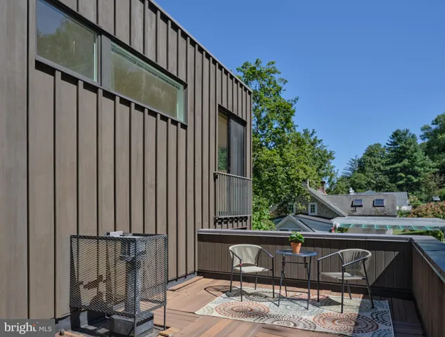 a view of balcony with wooden floor and outdoor seating