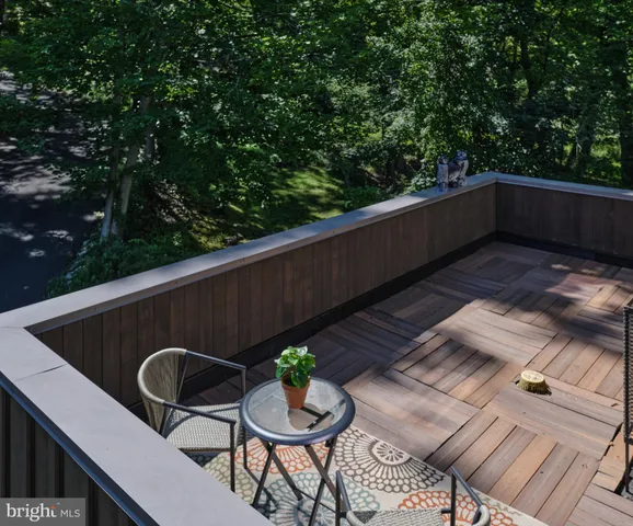 a backyard of a house with wooden floor and outdoor seating