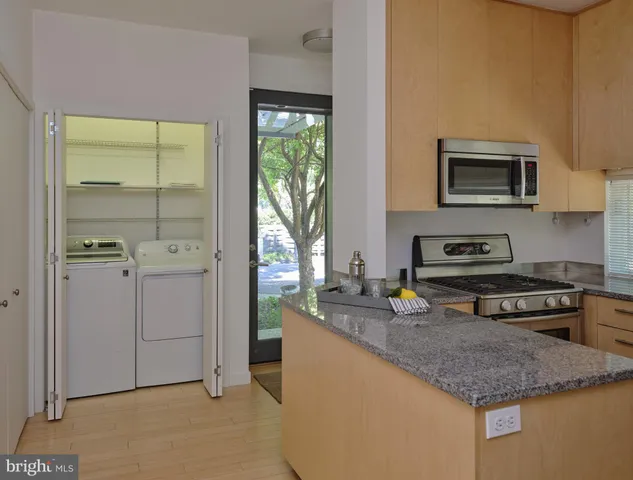 a kitchen with stainless steel appliances granite countertop a stove and a granite counter tops