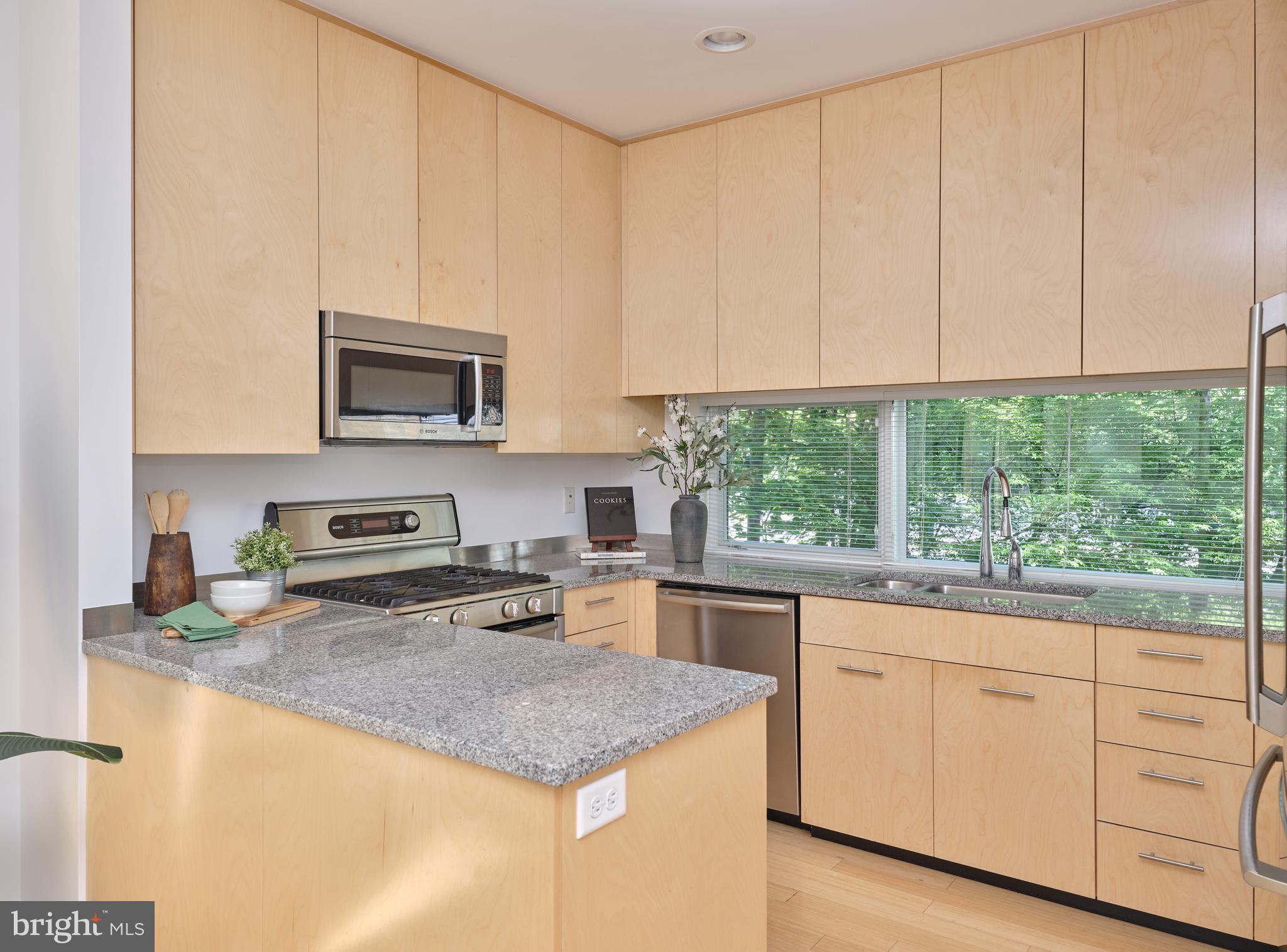 7189 Centerbridge Road New Hope, PA 18938 - Photo 27 of 48 a kitchen with granite countertop white cabinets and a window