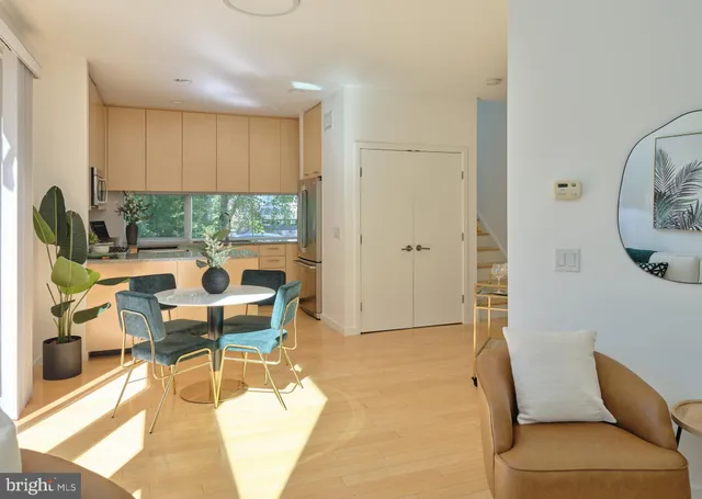 a living room with furniture a rug and a floor to ceiling window