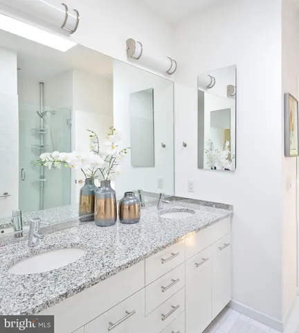 a bathroom with sink granite and mirror