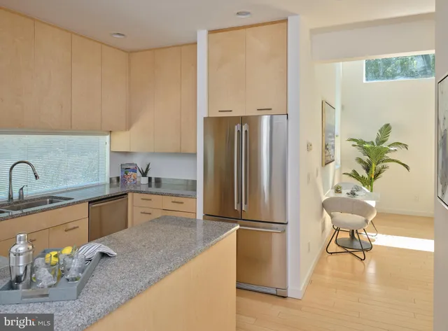 a kitchen with stainless steel appliances granite countertop a refrigerator and a sink