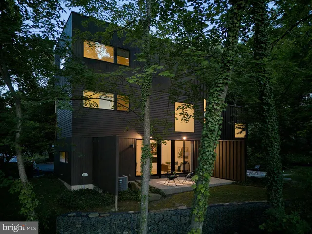 a view of a chairs and fire pit in a yard