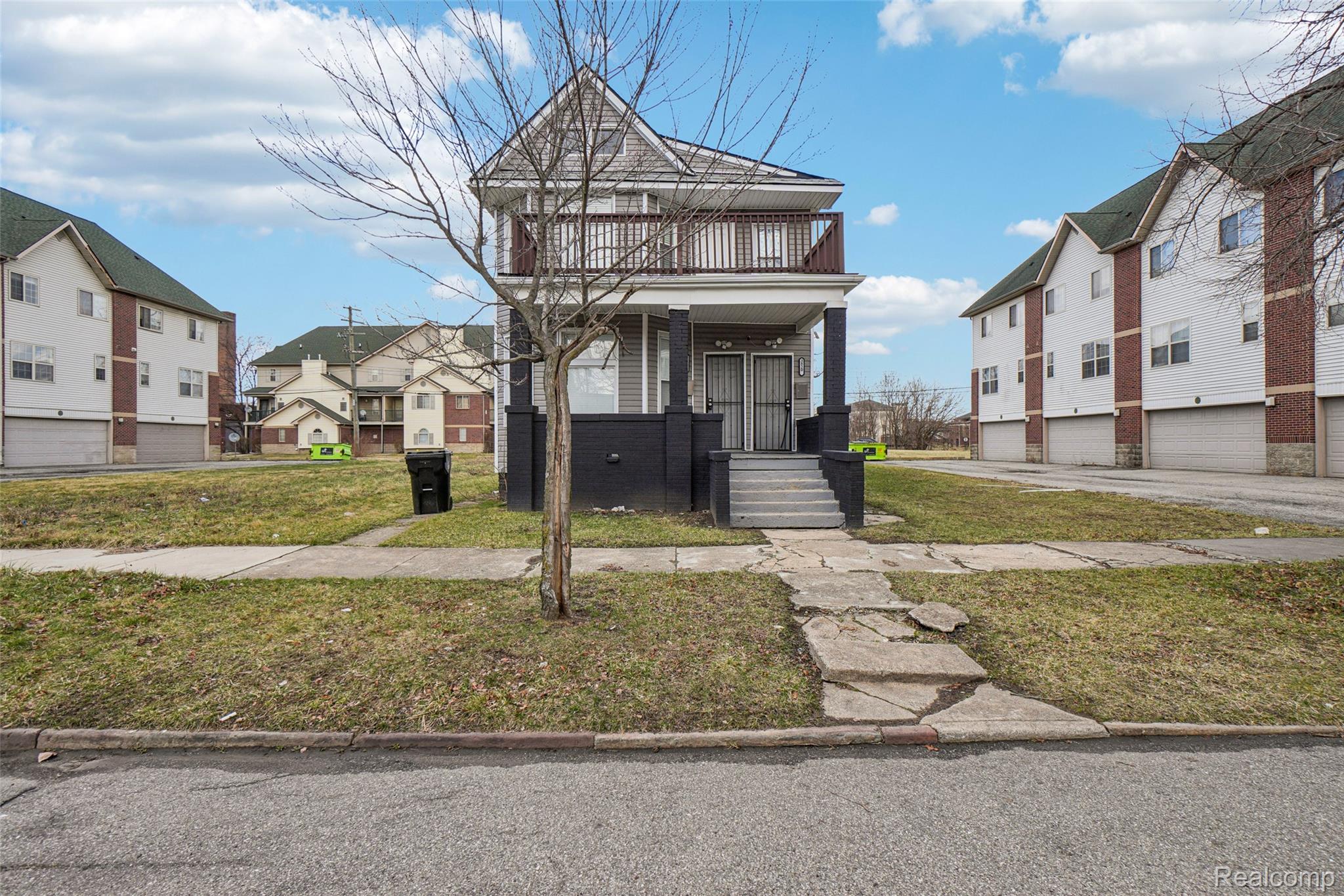 3822 Wabash Street Detroit, MI 48208 - Photo 1 of 17 View of front of home featuring a front lawn, a residential view, and a balcony