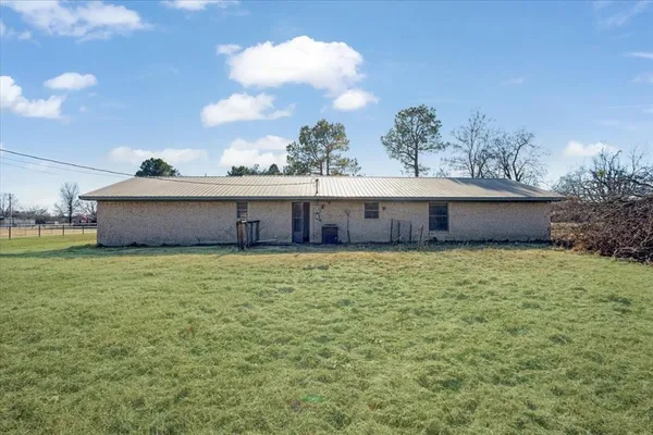 a view of a house with a yard and sitting area