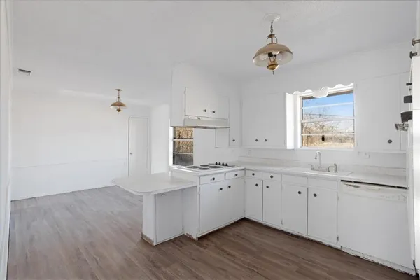 a kitchen with granite countertop white cabinets and white appliances