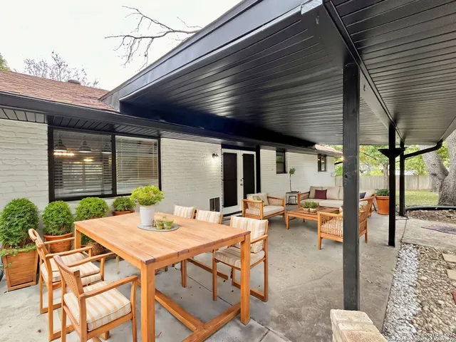 a outdoor space with a table and chairs
