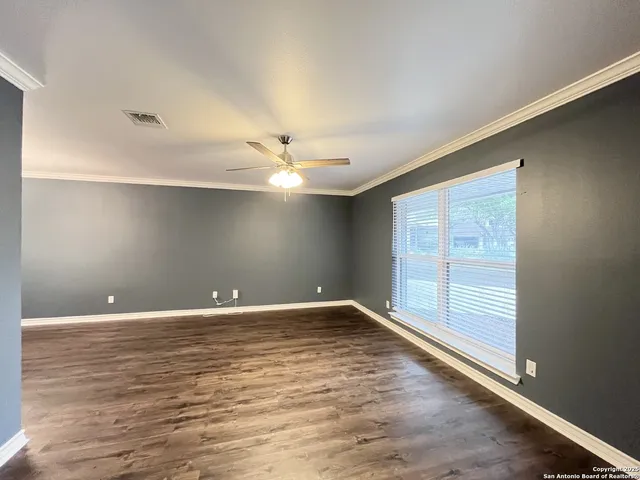 wooden floor in an empty room with a window