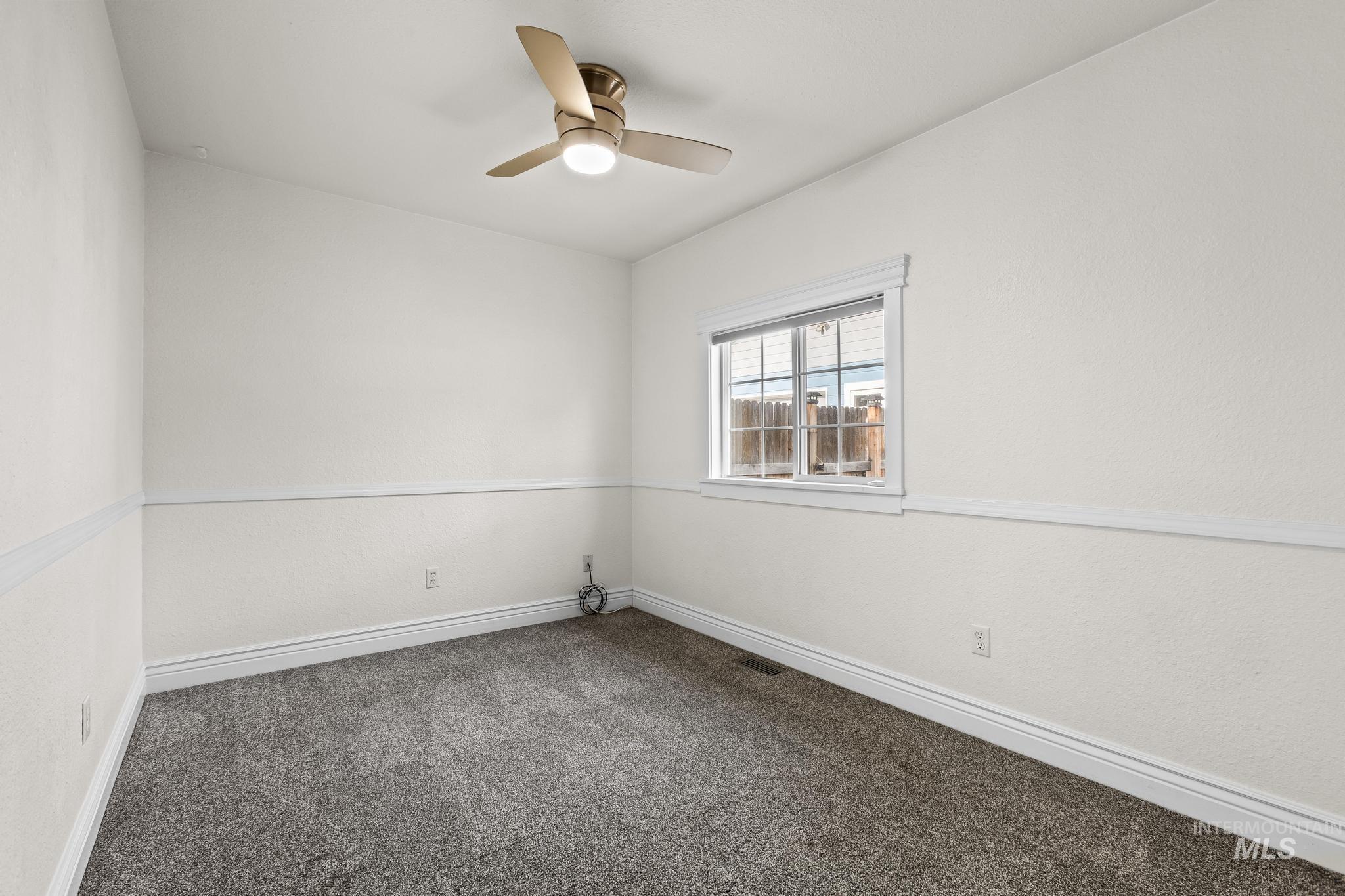 7514 West Swift Lane Boise, ID 83704 - Photo 19 of 46 Unfurnished room with carpet and ceiling fan