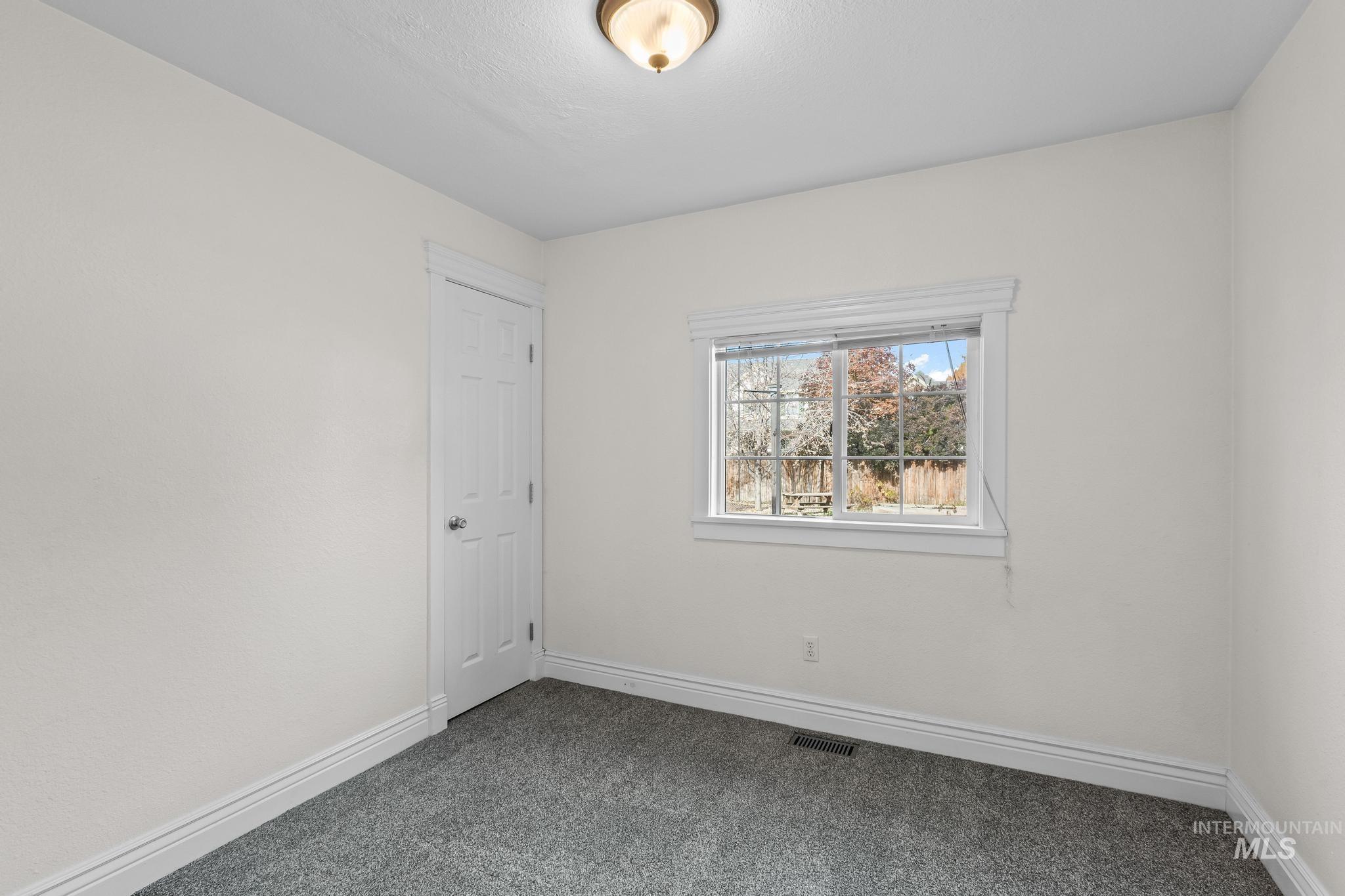 7514 West Swift Lane Boise, ID 83704 - Photo 21 of 46 Carpeted spare room featuring baseboards
