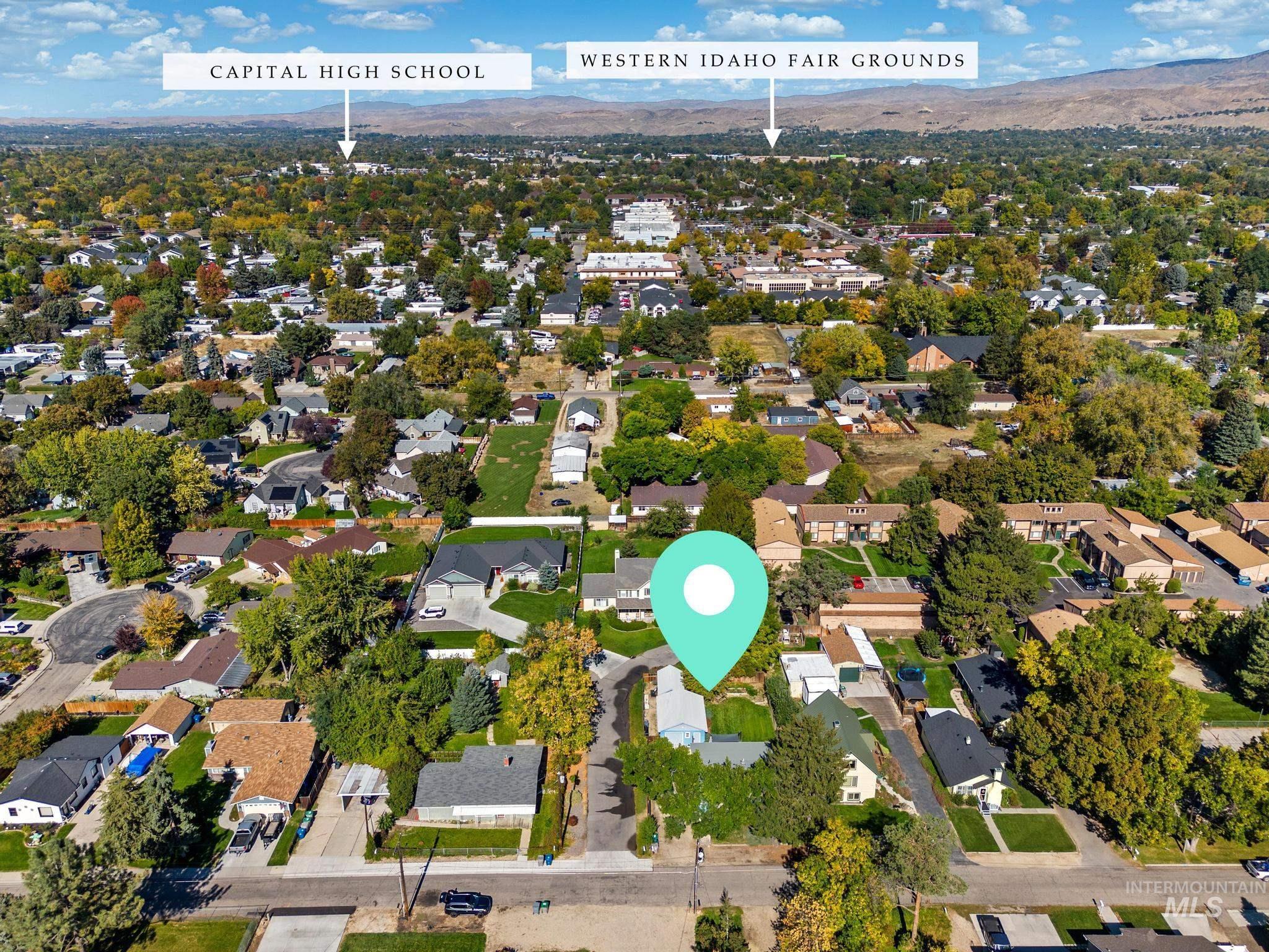 7514 West Swift Lane Boise, ID 83704 - Photo 32 of 46 Aerial view of property's location with nearby suburban area and a mountain backdrop
