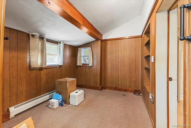 a view of a hallway with workspace and windows