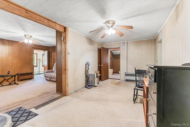 a view of a livingroom with furniture and a ceiling fan