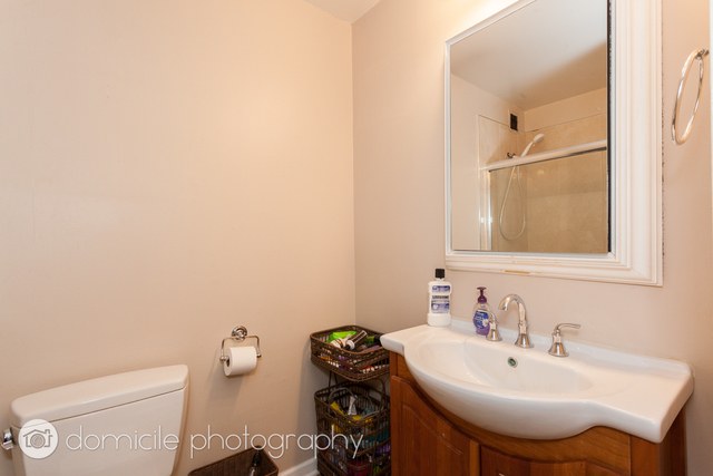 Undisclosed Address Chicago, IL 60614 - Photo 5 of 12 a bathroom with a sink a toilet and mirror