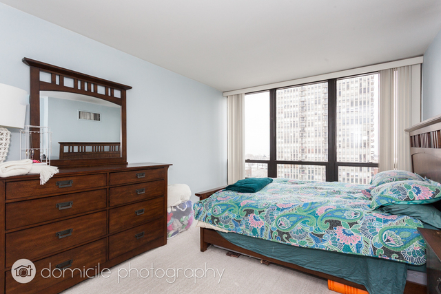 Undisclosed Address Chicago, IL 60614 - Photo 6 of 12 a bedroom with a bed and a window