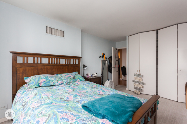 Undisclosed Address Chicago, IL 60614 - Photo 7 of 12 a bedroom with a bed and a window