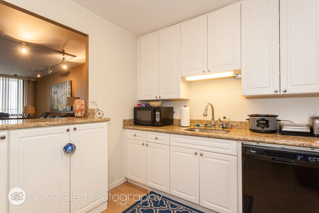 Undisclosed Address Chicago, IL 60614 - Photo 8 of 12 a kitchen with granite countertop white cabinets and white appliances
