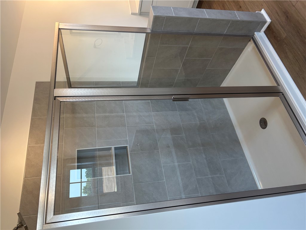 211 Bellflower Lane Anderson, SC 29625 - Photo 19 of 28 A sleek, tiled shower with glass enclosure offers a refreshing daily retreat.