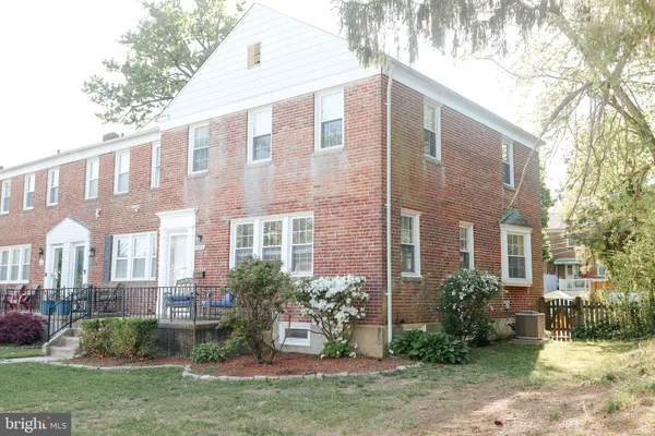 a view of a brick building next to a yard