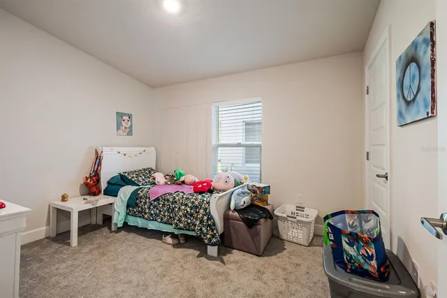 a bedroom with furniture and a window