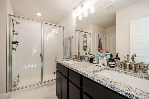 a bathroom with a granite countertop sink mirror and double