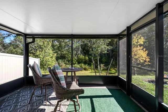 a view of a porch with furniture and wooden floor