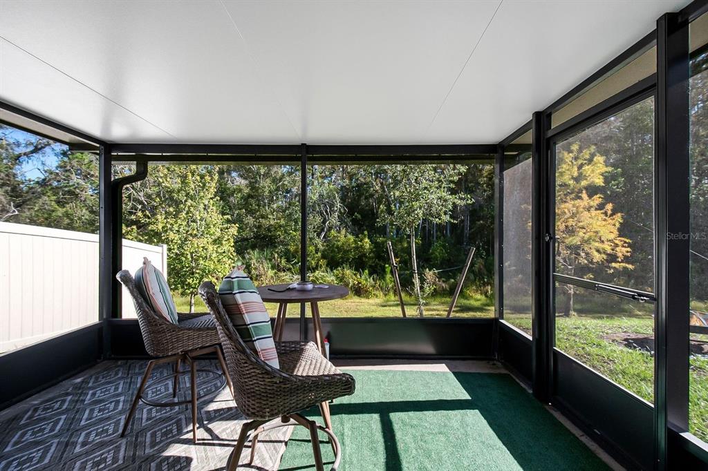 3711 Sagefield Drive Harmony, FL 34773 - Photo 16 of 18 a view of a porch with furniture and wooden floor