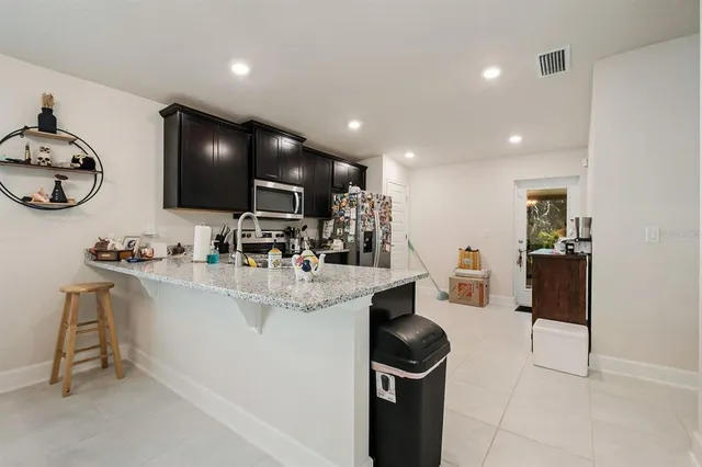 a view of kitchen with sink wooden floor and furniture