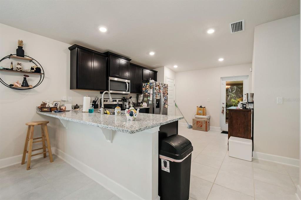 3711 Sagefield Drive Harmony, FL 34773 - Photo 6 of 18 a view of kitchen with sink wooden floor and furniture
