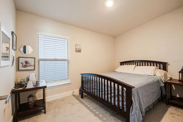 a spacious bedroom with a bed and a window