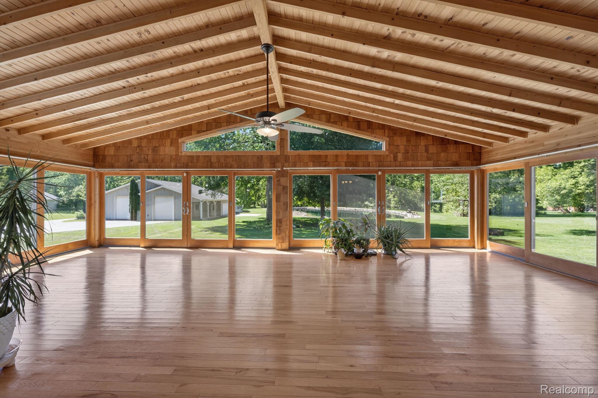 9353 Hill Road Swartz Creek, MI 48473 - Photo 32 of 98 Expansive sunroom featuring natural wood-finish flooring and a vaulted wood-paneled ceiling