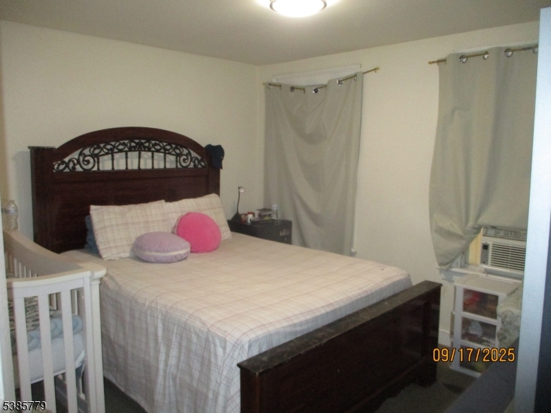 7 Kossuth Street Newark, NJ 07105 - Photo 11 of 18 a bedroom with a bed and a dresser
