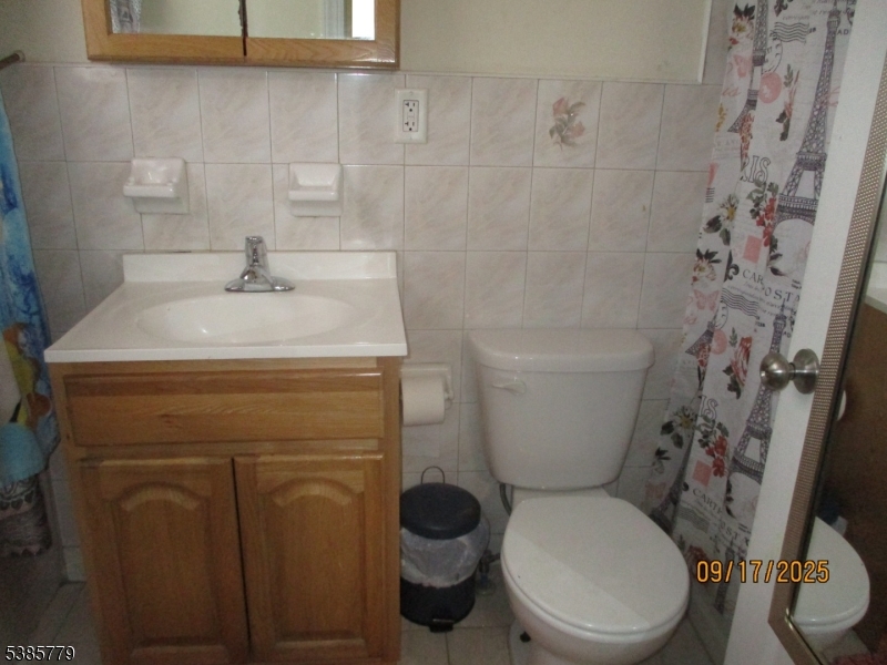 7 Kossuth Street Newark, NJ 07105 - Photo 12 of 18 a bathroom with a sink a toilet and a shower